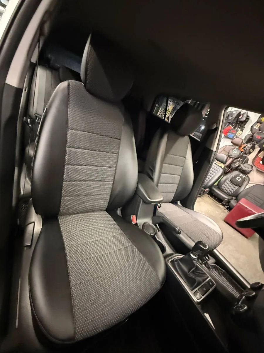 Передние сиденья Kia Rio в чехлах из черной экокожи и серой автоткани с горизонтальной прострочкой, вид со стороны водительской двери